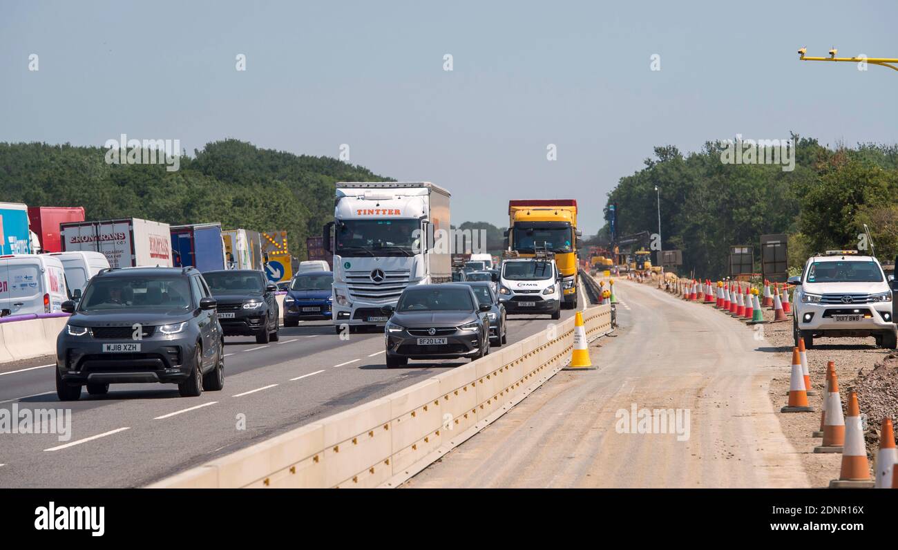 Traffic travelling alongside roadworks on the M1 motorway in the Midlands, England. Stock Photo