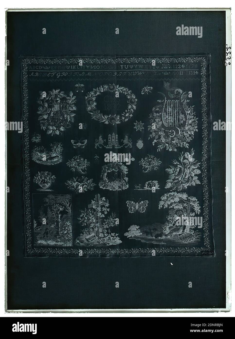 Wilhelm Weimar, sampler, glass negative, black and white negative process, total: height: 23,8 cm; width: 17,8 cm, numbered: right: in black ink: 2522nd, work of applied arts (textiles), ornaments, letters, alphabet, writing, number, flower ornaments, plant ornaments, cupids with attributes of arts, sciences etc, butterfly, cherry, musical instruments, cornucopia, coat of arms (state symbol Stock Photo