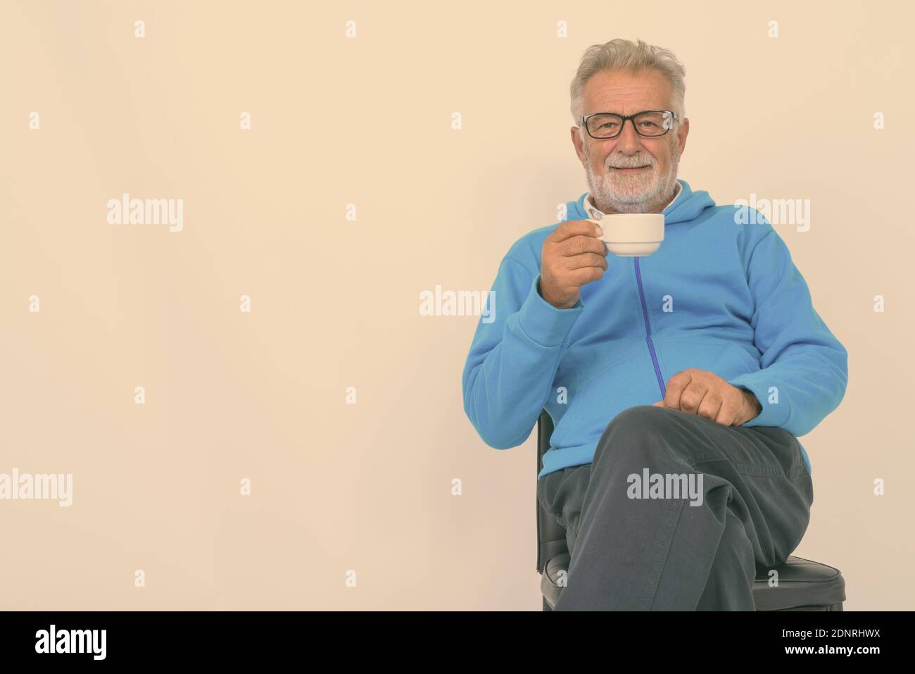 Man sitting chair studio shot hi-res stock photography and images - Alamy