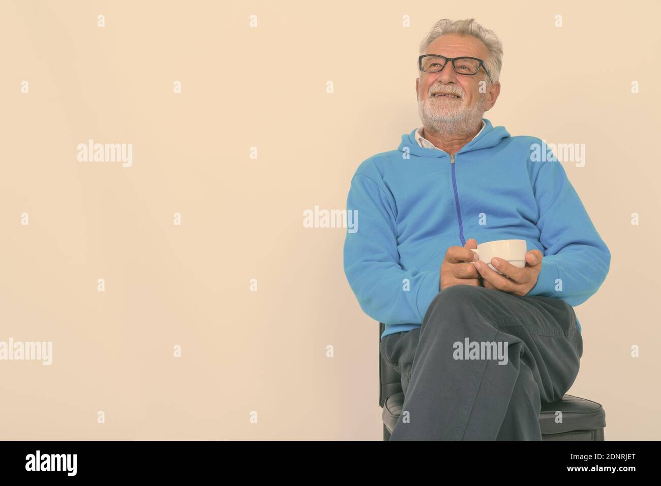 Man sitting chair studio shot hi-res stock photography and images - Alamy