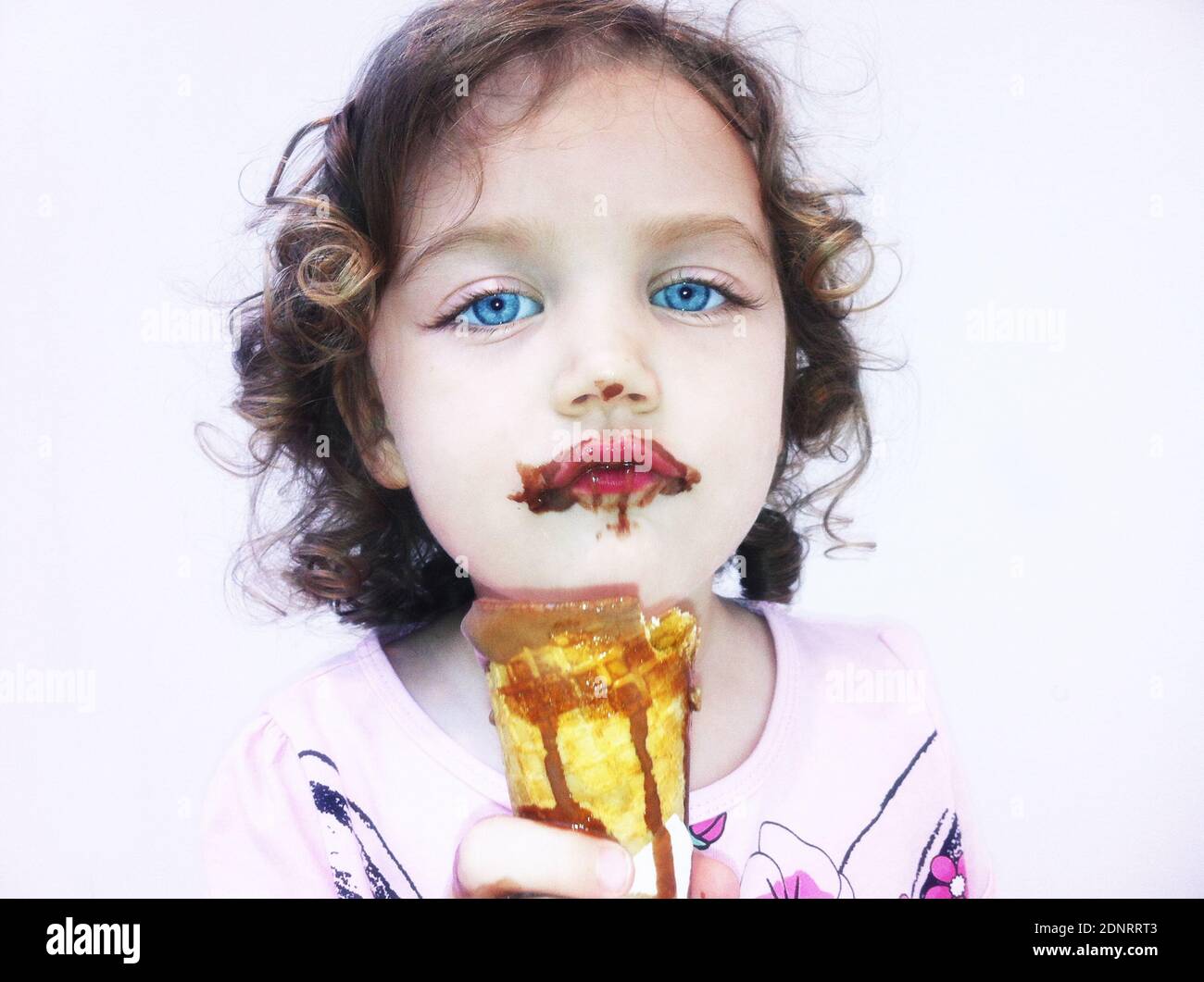 Portrait of a girl eating chocolate icecream that's melting Stock