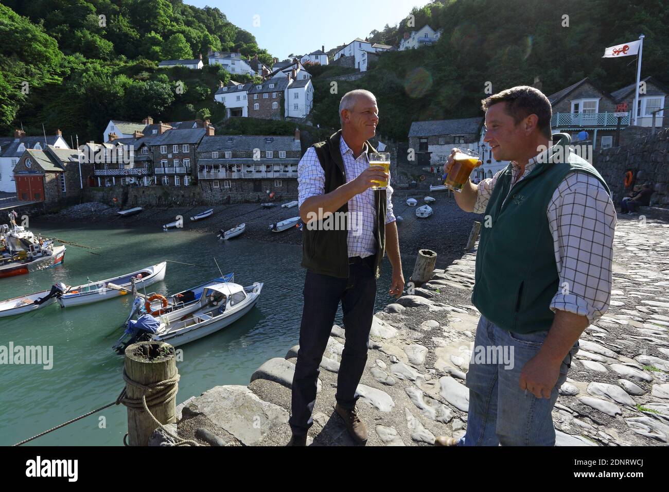 United Kingdom / Devon / Clovelly Estate / Worker having a pint in the harbour near The Red Lion Pub Stock Photo