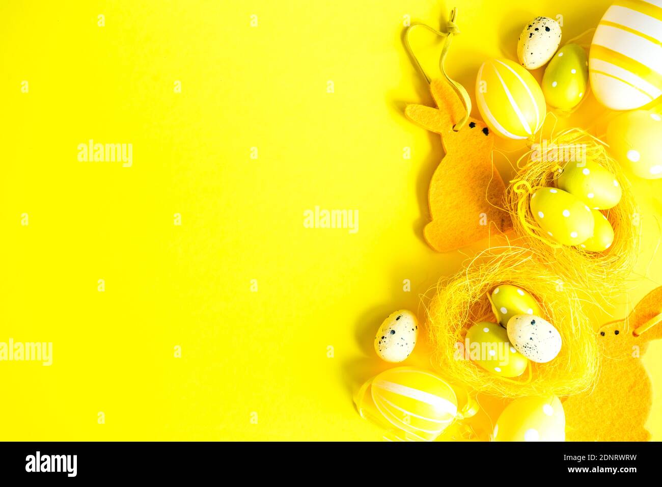 Easter egg and Easter bunny arrangement on a yellow background Stock Photo