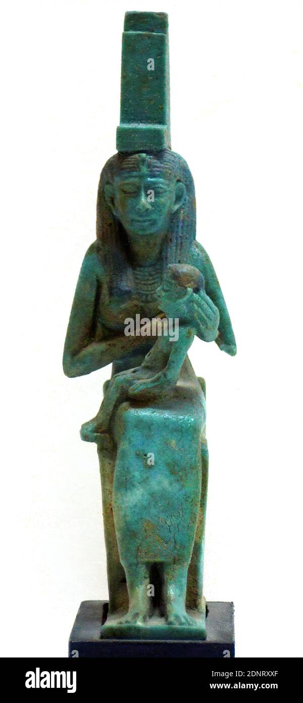 Amulet (Isis with the Horus Boy), faience, fired, faience, total: height: 10.2 cm; width: 1.7 cm (base); depth: 5.3 cm (base), Jewelry for body and clothing (women's clothing), Jewelry for body and clothing (men's clothing), Small sculptures/small sculptures, Isis, the mother goddess, Horus, son of Osiris and Isis, Antiquity, The goddess Isis sits on a throne, the sides of which have a square shape with scales in relief. The rear lower quarter bears a heraldic plant, as does the entire side surface, surrounded by a knucklebone frame. Stock Photo