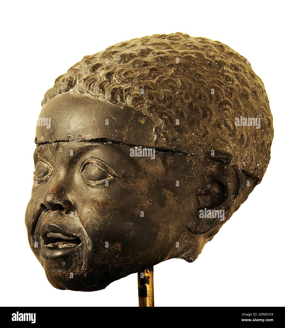 Head of an African boy, basalt, greywacke, chiseled, painted, basalt, chiseled and painted, Total: Height: 19.7 cm; Width: 17.2 cm; Depth: 20 cm, sculptures, African, child, head, face, late Hellenistic, head of a child with open mouth and large, expressive eyes as well as remains of the former painting. Because of his physiognomic features, an African can be recognized in him. The head is broken off diagonally at the base of the neck and split into two parts by a transverse fracture. Pieces of the neck, the right ear and the right brow arch are missing. Stock Photo