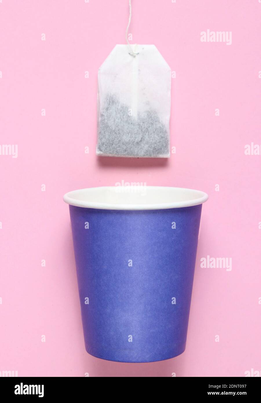 Empty disposable paper cup for tea, tea bag on pink pastel background ...