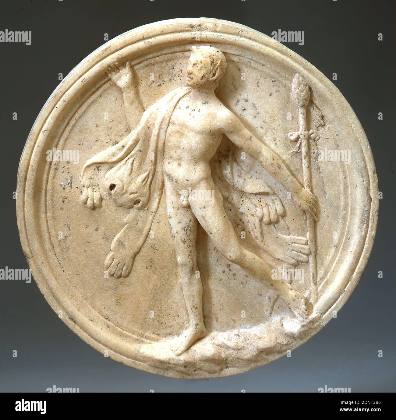 Oscillum (Satyr), Marble, chiseled, smoothed, Marble, Total: Height: 6 cm; Diameter: 35.5 cm, Reliefs, Three-dimensional sculptures, Garden and park, Ornamental objects, Satyrs, Fauns, Silene, Early Imperial Period, Roman Antiquity, The disc belongs to the genus Oscilla. In archaeology it is understood to be objects and reliefs, which were usually hung in the intercolumnar spaces of porticoes (Lat. porticus). Their manner of attachment can be reconstructed from Roman wall paintings and isolated find situations. Stock Photo