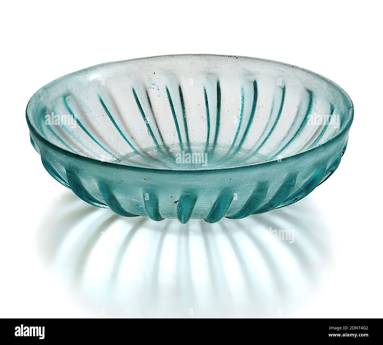 Ribbed Bowl, Glass, pressed, blown into shape, Glass, Total: Height: 4.4 cm; Diameter: 16.4 cm, Drinking and barware, Burial objects, Early Imperial period, Roman antiquity, The flat ribbed bowl is almost transparent. It has 23 ribs on the outside; inside there are two concentric grooves (double slit ring Stock Photo