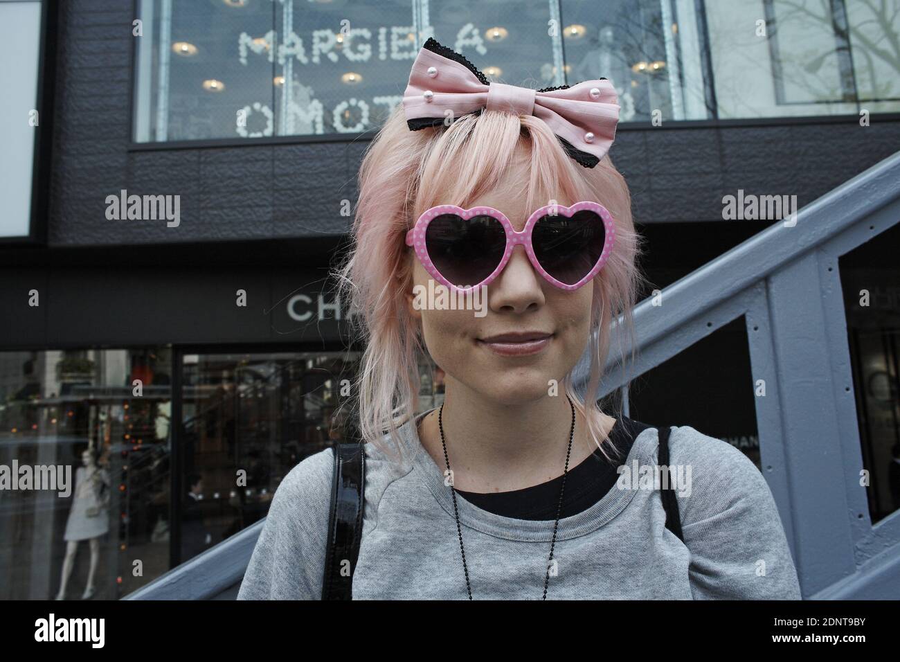 JAPAN / Tokyo / Omotesando / Girl with pink glasses posing in Tokyo's fashion district, there are boutiques and designer shops Stock Photo