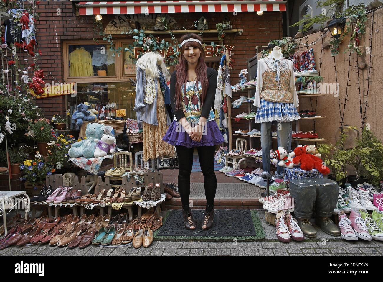 Girl posing in front of second hand vintage shop in Harajuku , Tokyo,Japan. Stock Photo
