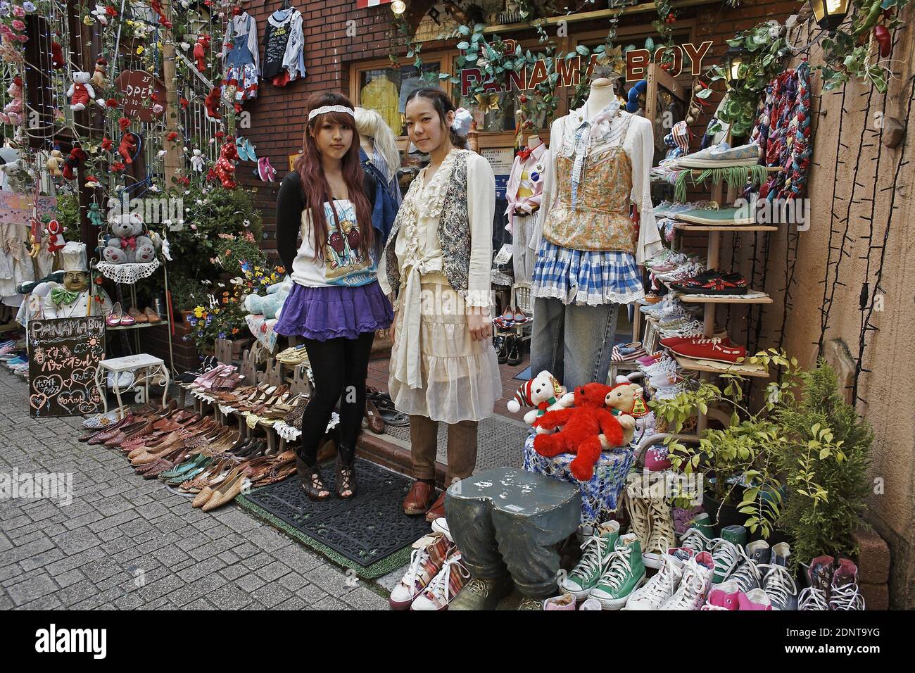 JAPAN / Tokyo / Two girls posing in front of second hand vintage shop in Harajuku . Stock Photo