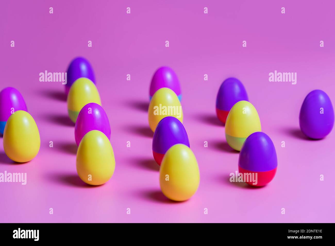 Colorful Plastic Easter Eggs on pink background Stock Photo