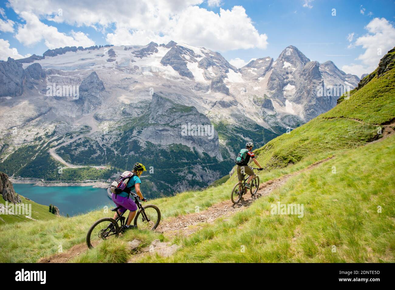 Man and woman mountain biking in the Dolomites, Val Gardena, South Tyrol, Italy Stock Photo