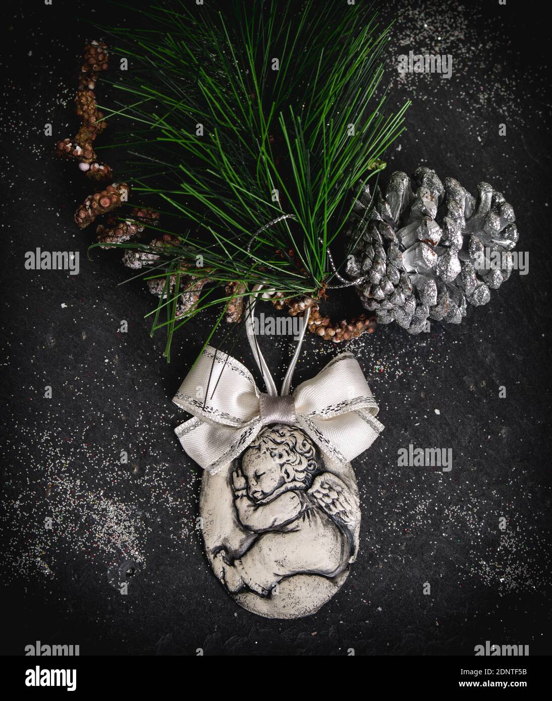 Rustic Christmas decoration with an ornament, pinecone and fir branch Stock Photo