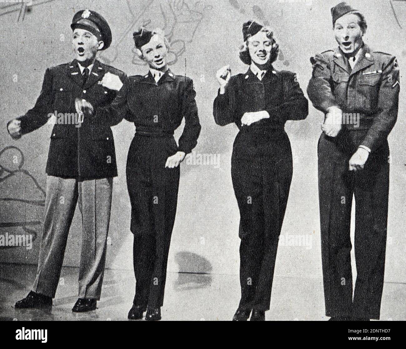 Photograph of Bing Crosby, Vera-Ellen, Rosemary Clooney, and Danny Kaye performing a number from 'White Christmas'. Stock Photo