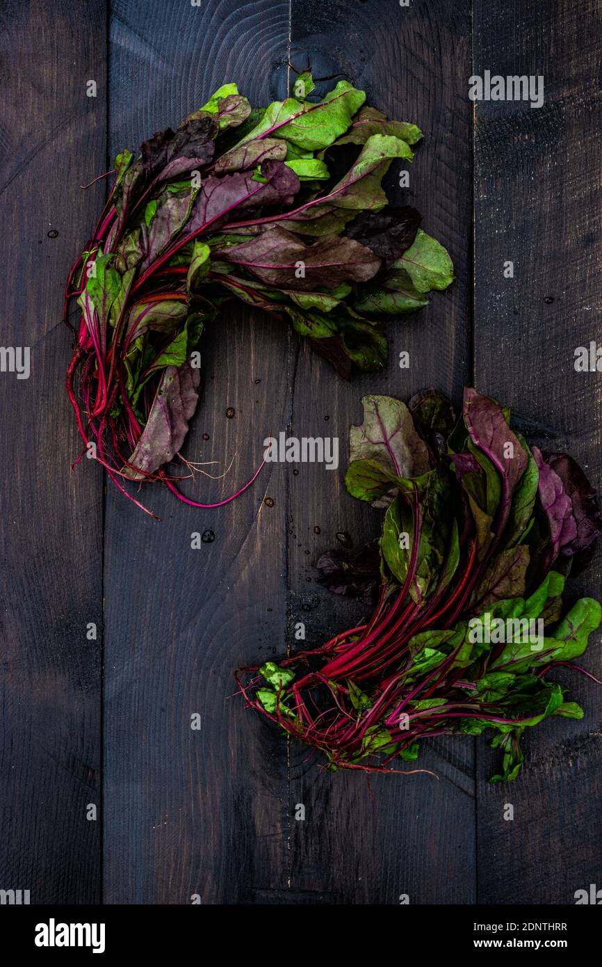 Fresh beetroot leaves on a wooden table Stock Photo