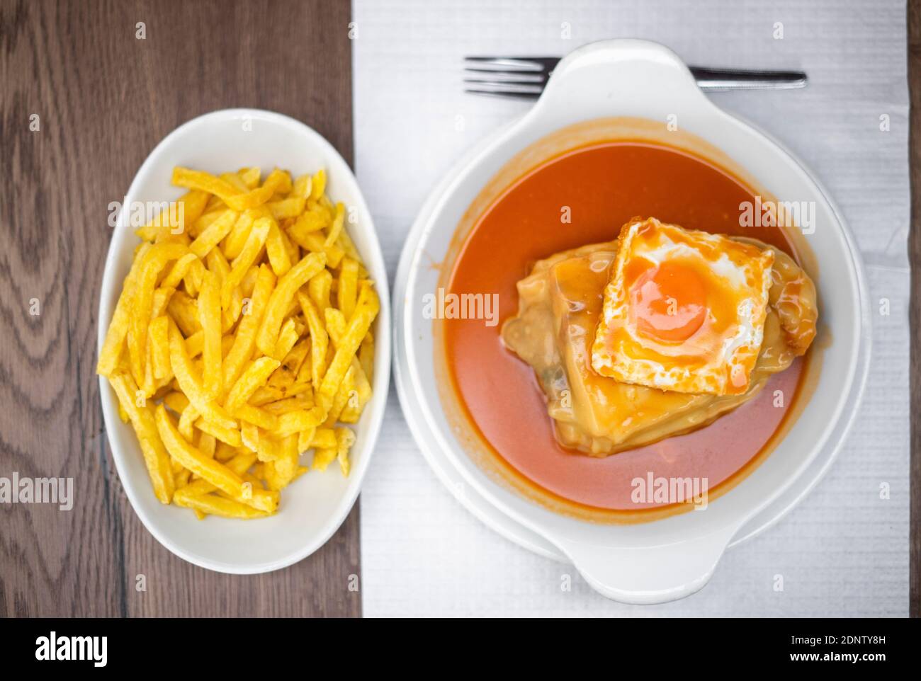 Famous traditional food from Porto called francesinha with french fries, Portugal Stock Photo