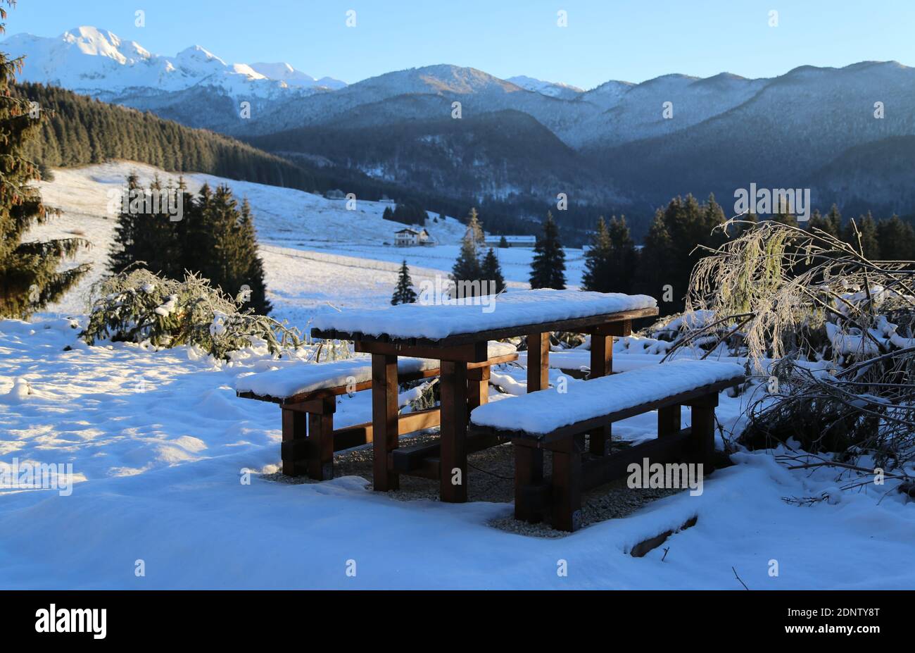 Table with chairs under the snow on the Cansiglio plateau, Italy Stock Photo