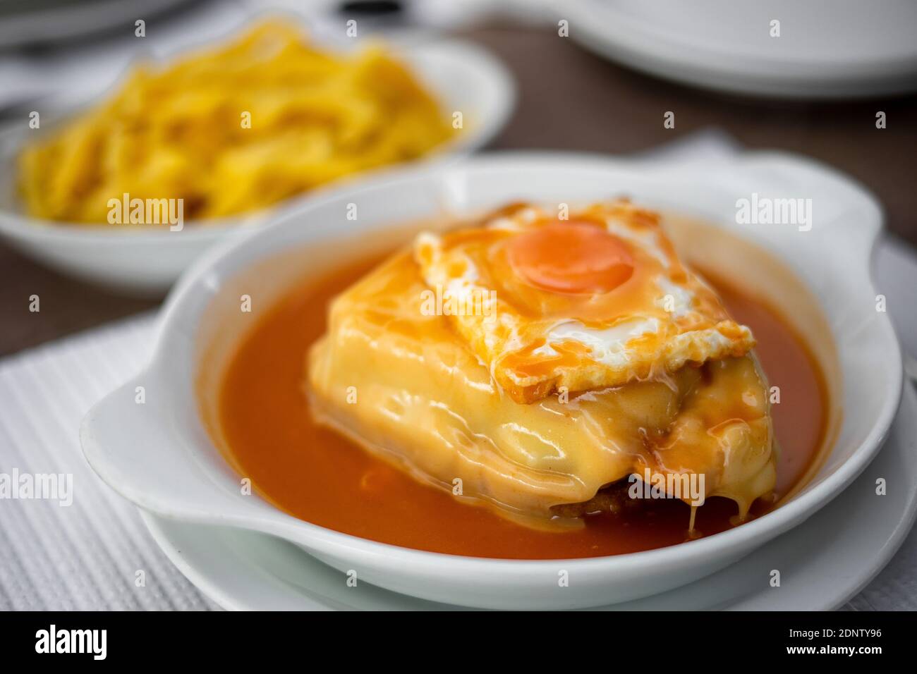 Famous traditional food from Porto called francesinha with french fries, Portugal Stock Photo