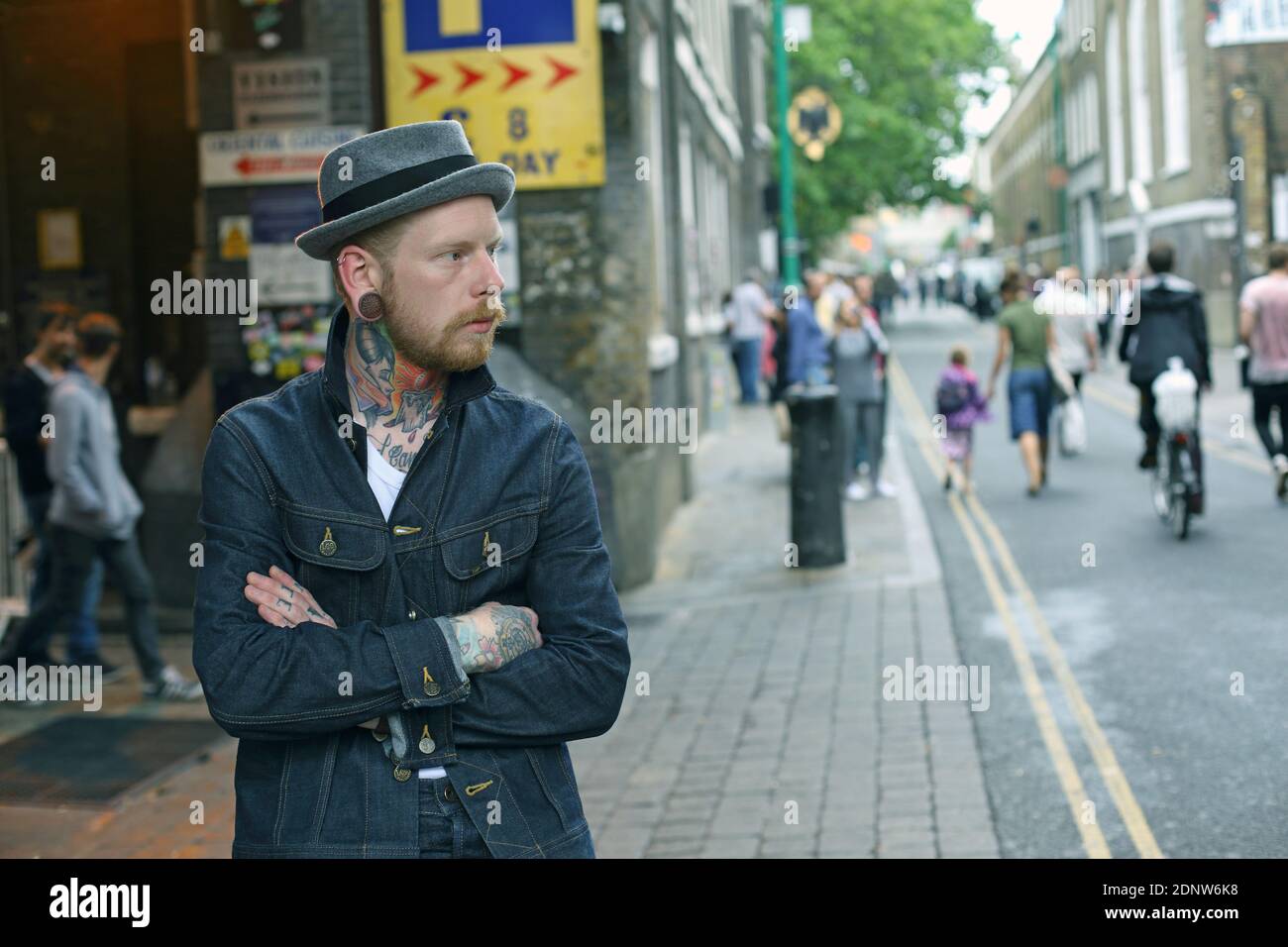 a man with tattoos in bricklane, east london Stock Photo