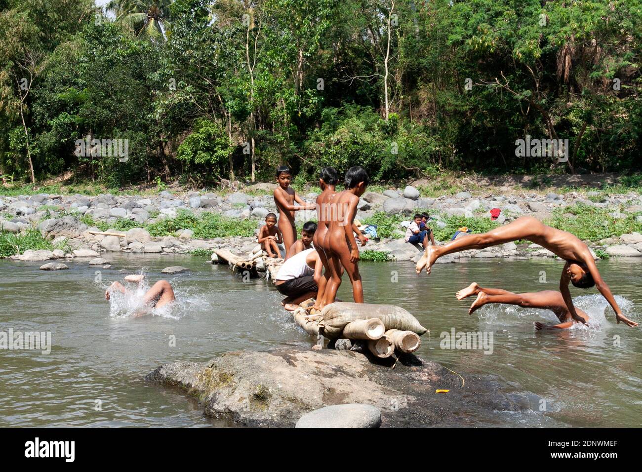 Residents in Taman Krocok village, Bondowoso, use the river for bathing and  for playing Stock Photo - Alamy
