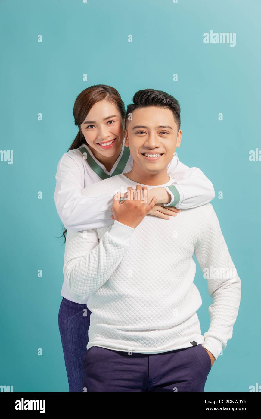 Happy smiling couple in love. Over blue background Stock Photo - Alamy