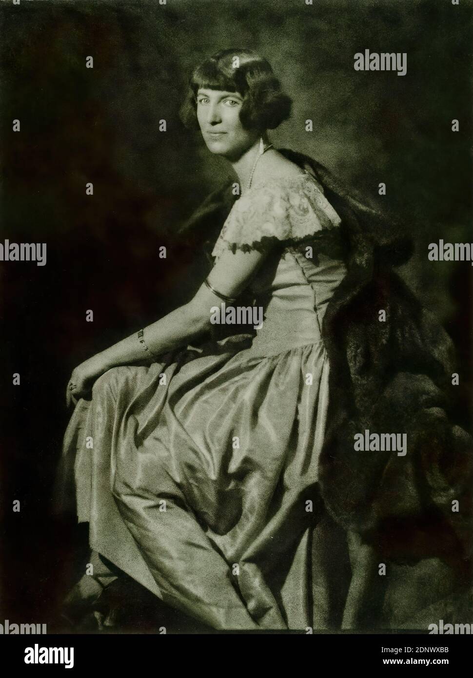 Franz Grainer, Portrait of a woman, Staatliche Landesbildstelle Hamburg, collection on the history of photography, paper, brome oil print, image size: height: 46,2 cm; width: 34 cm, signed: recto u. re. in lead: Grainer, stamp: verso and left: stamp and object inscription of the Staatliche Landesbildstelle Hamburg, portrait photography, full-length portrait, half profile (three-quarter view), sitting figure, fashion, clothing, woman, portrait Stock Photo