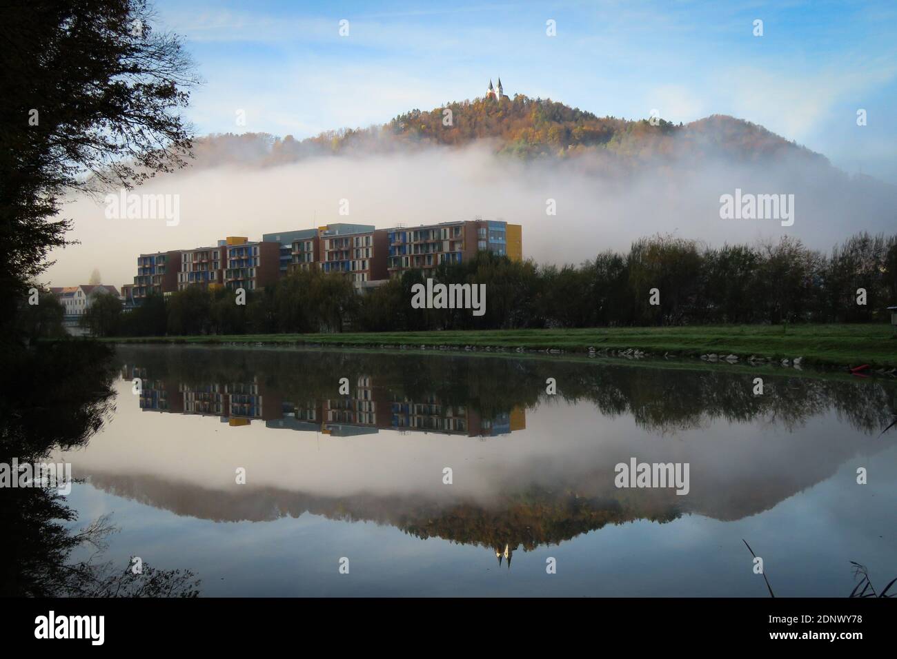 Reflection Of Trees And Buildings In Lake Against Sky Stock Photo