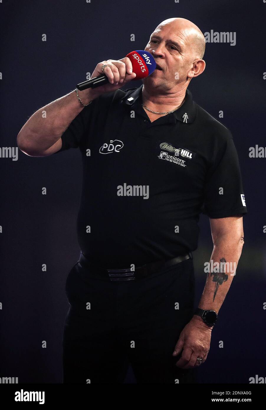 PDC referee Russ Bray on stage during day four of the William Hill World Darts Championship at ...