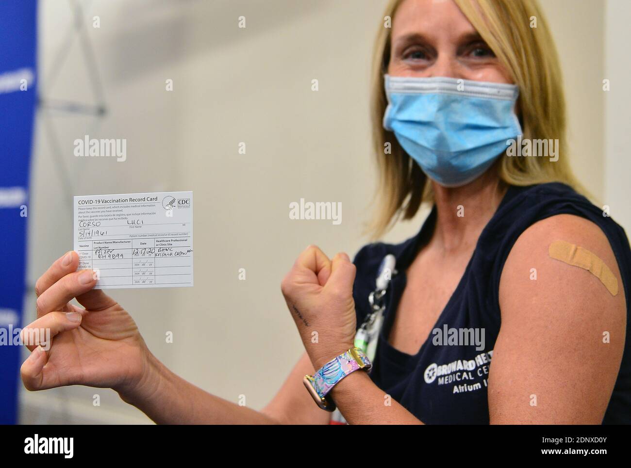 Fort Lauderdale, Florida, USA. 17th Dec, 2020. Lucy Corso, RN, Intensive  Care Unit, Broward Health Medical Center, flexes her arm as she shows off  her COVID-19 vaccine record card after receiving a