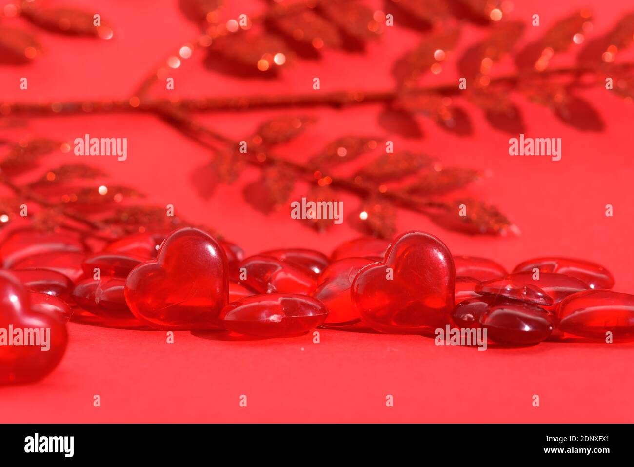 valentine's day mockup greeting card with red hearts on red background, for text place. festive wedding background, bluer focus. Stock Photo