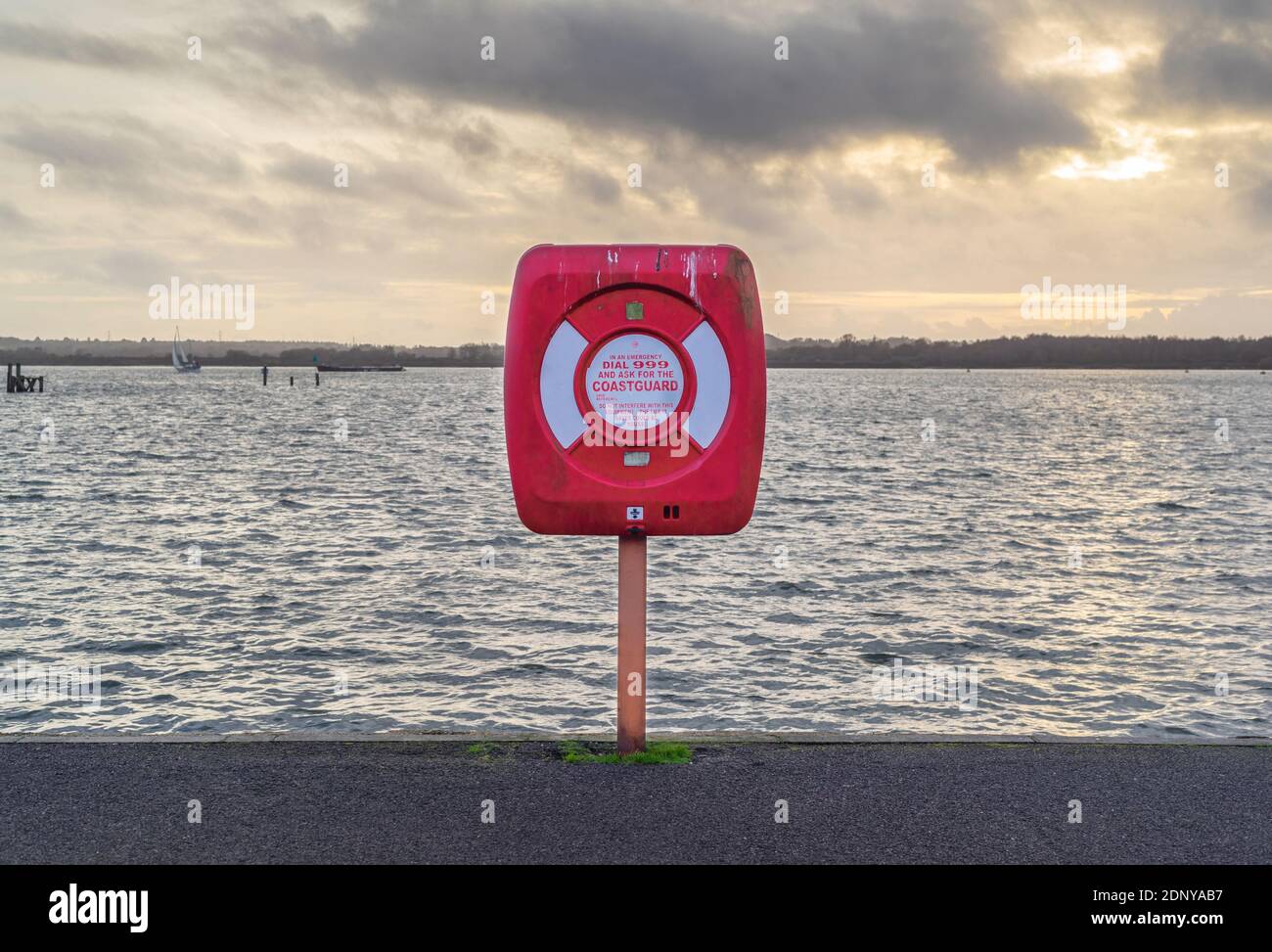 Red Coastguard warning sign and emergency phone number at Southampton waterfront, Southampton, England, UK Stock Photo