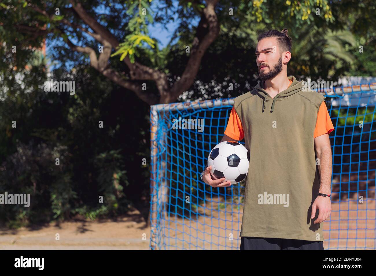 Handsome Hipster Football Player In Front Of The Goal Of An Urban Court With The Ball Under His Arm Concept Of Healthy Lifestyle And Urban Sport In T Stock Photo Alamy