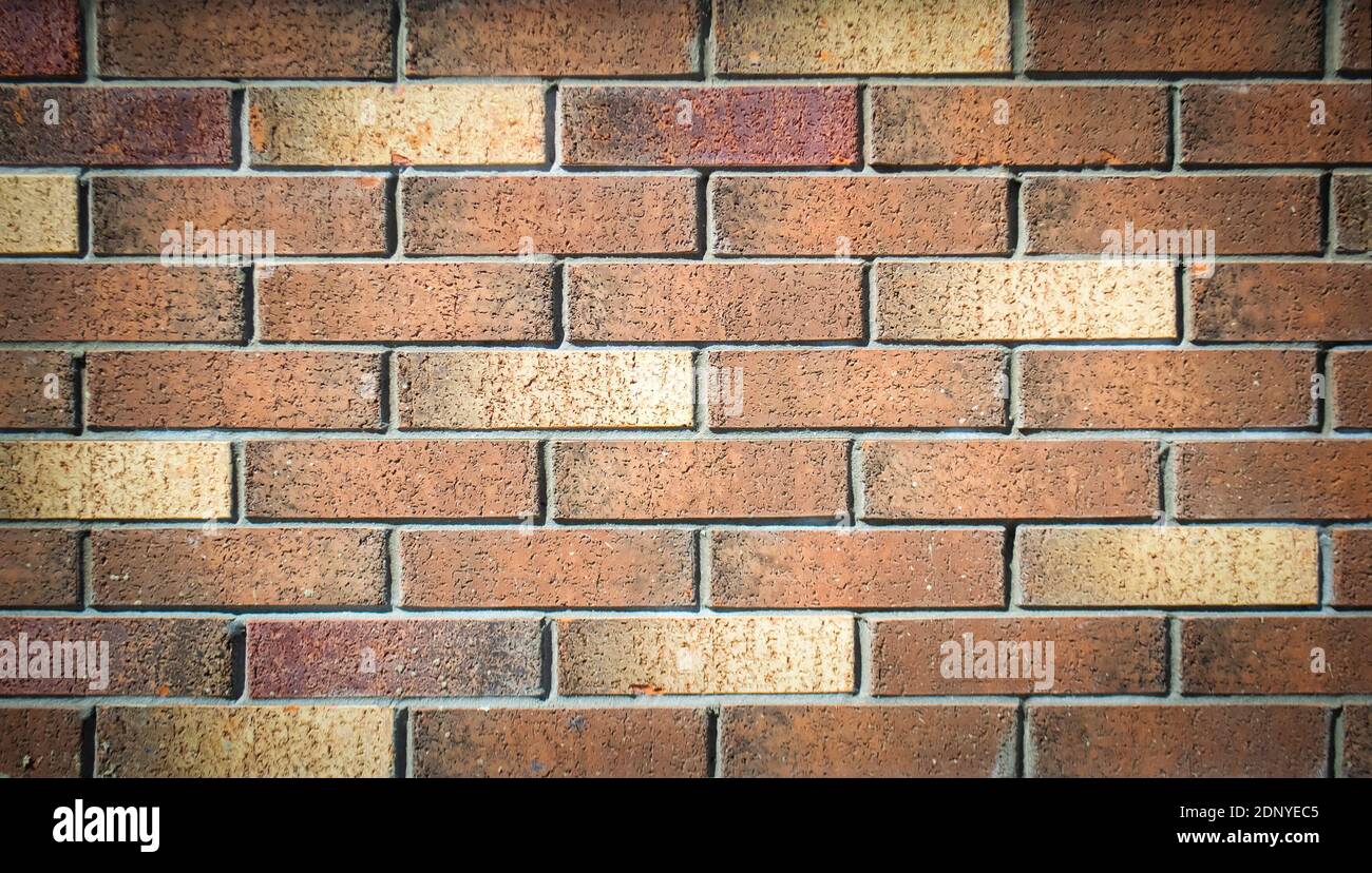 Old grunge brick wall texture with delicate vignetting. Stock Photo