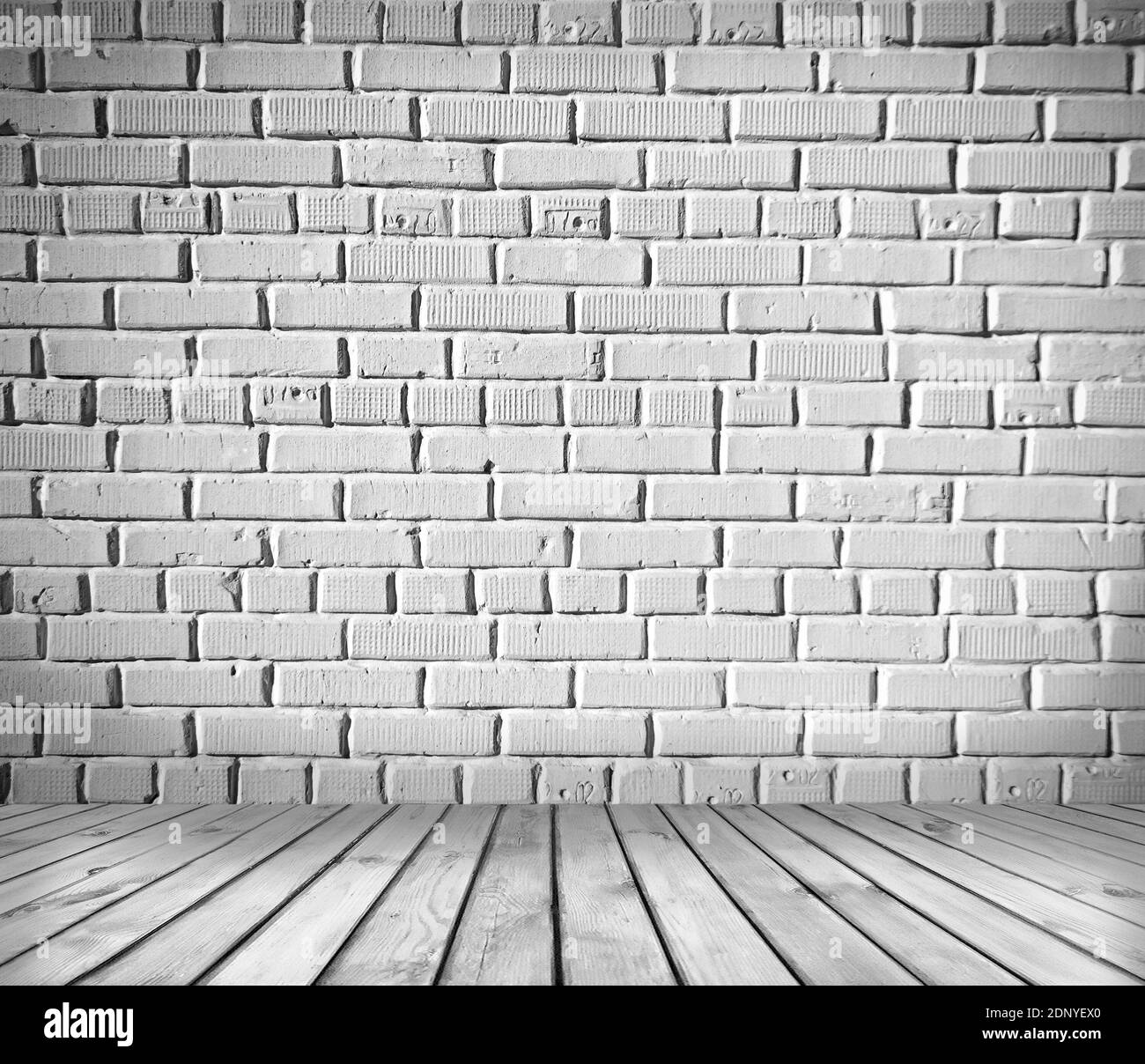 Room interior: white brick wall with old wooden floor Stock Photo