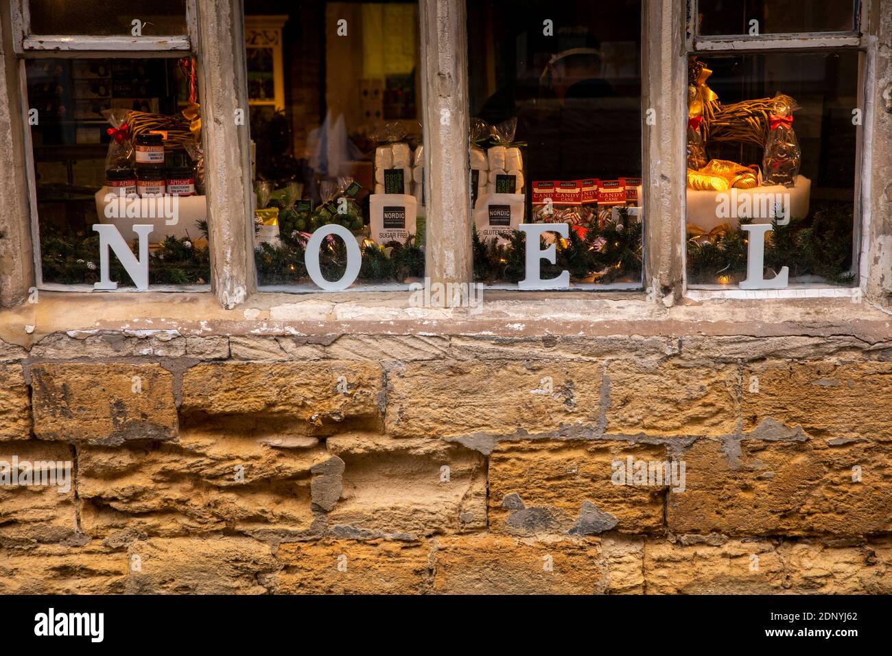 UK, Gloucestershire, Stow on the Wold, High Street, NOEL Christmas letters in window of Cotswold Chocolate shop Stock Photo