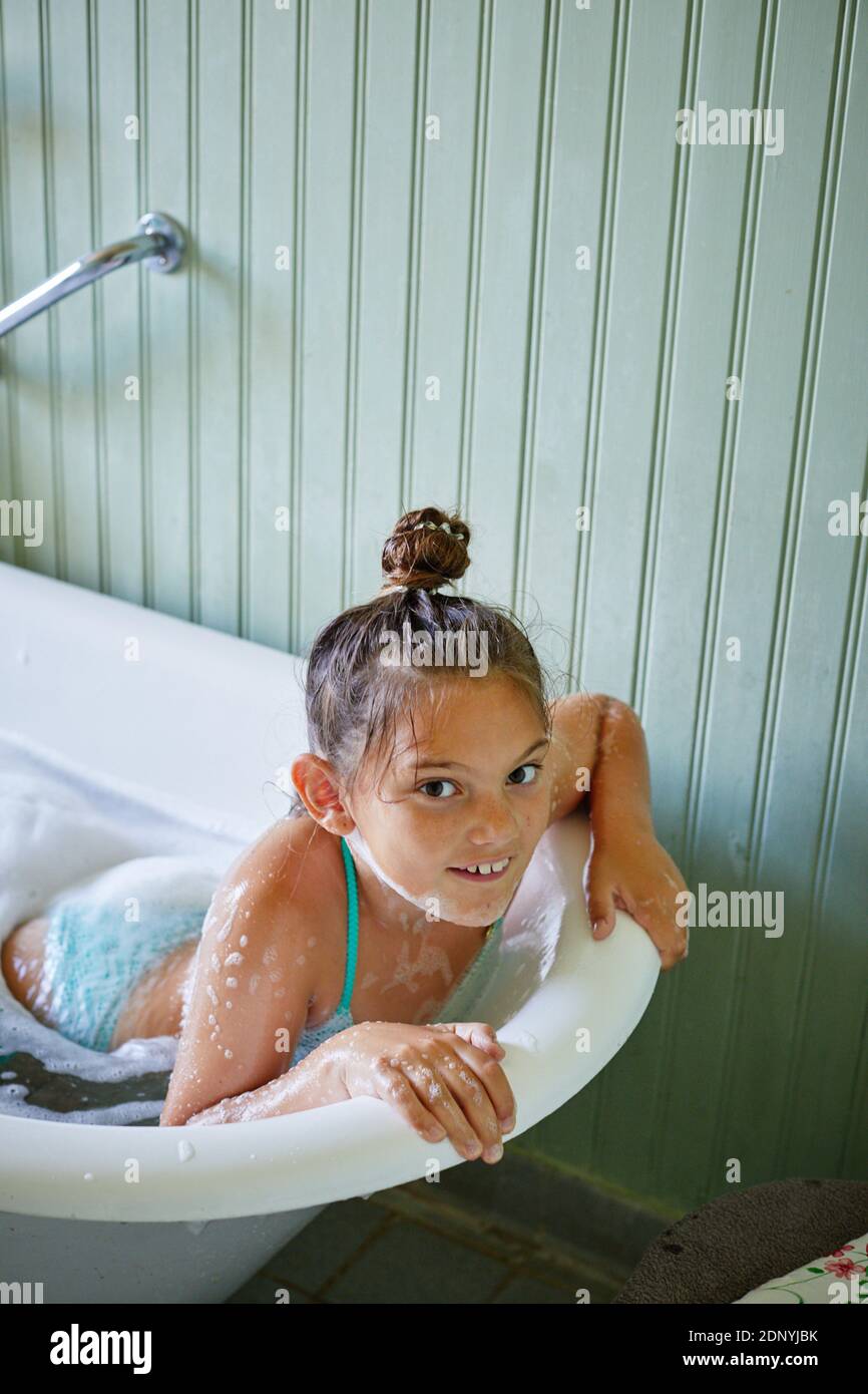 Smiling girl in bathtub Stock Photo