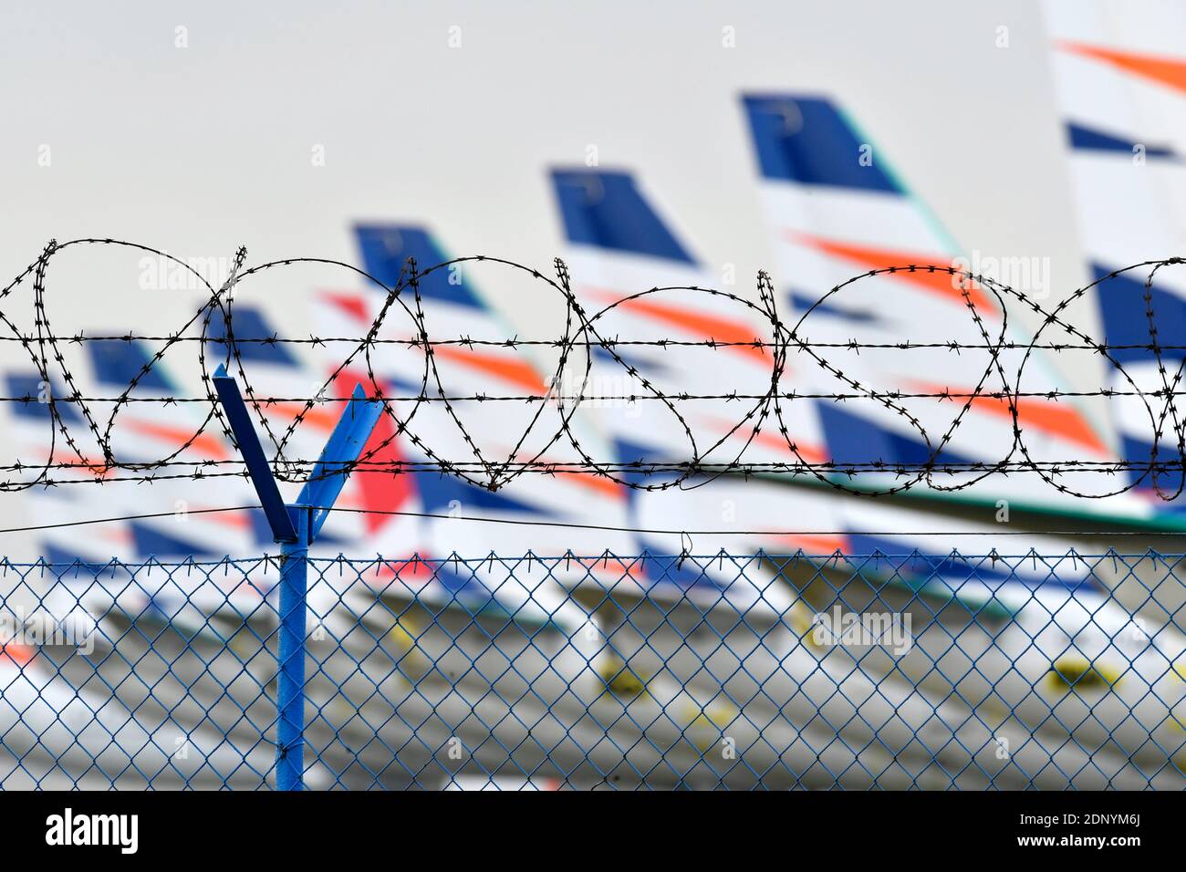 grounded planes behind the barbed wire during Covid-19 pandemy Stock Photo