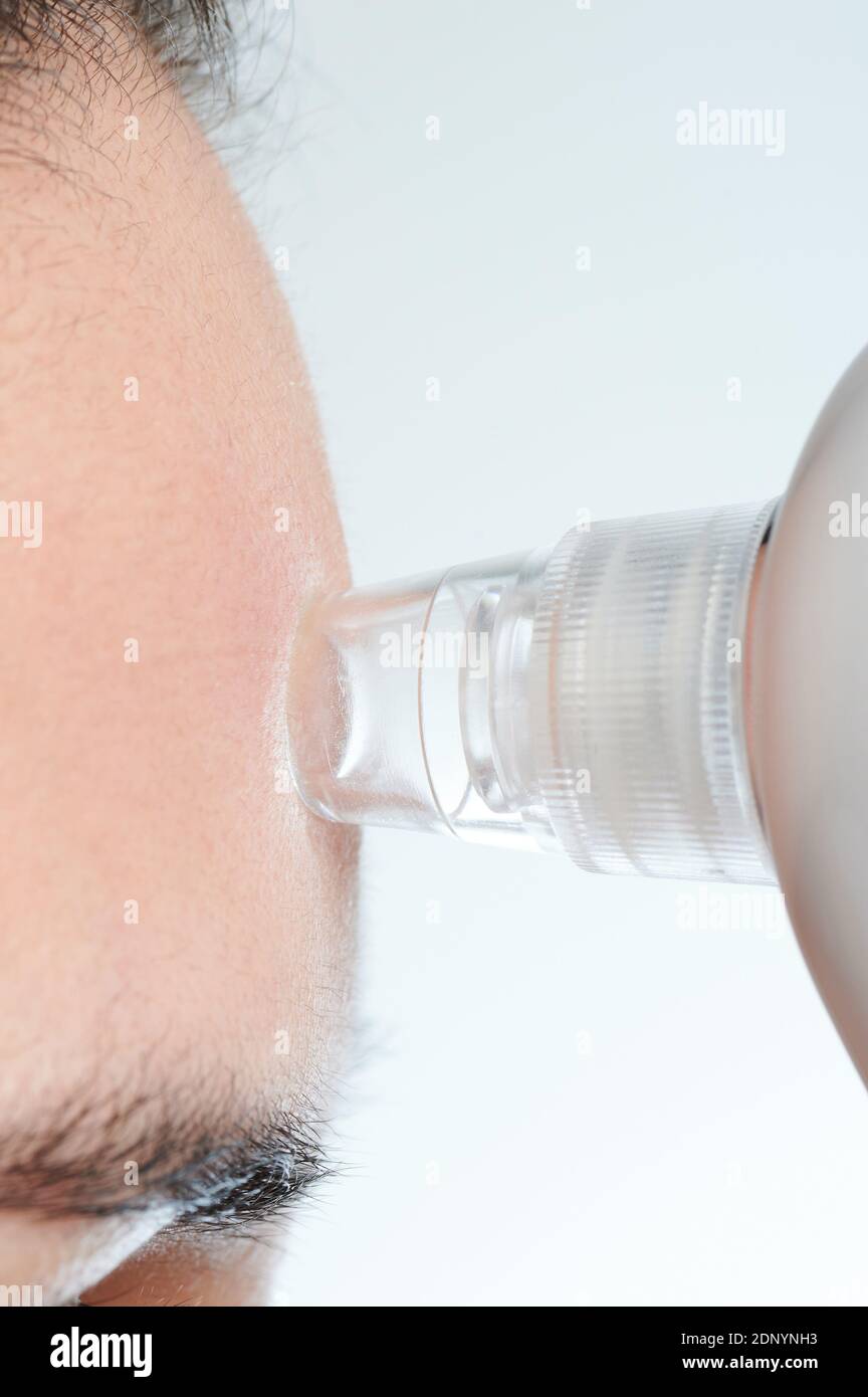 Cleaning forehead skin with remover tool macro close up view Stock Photo