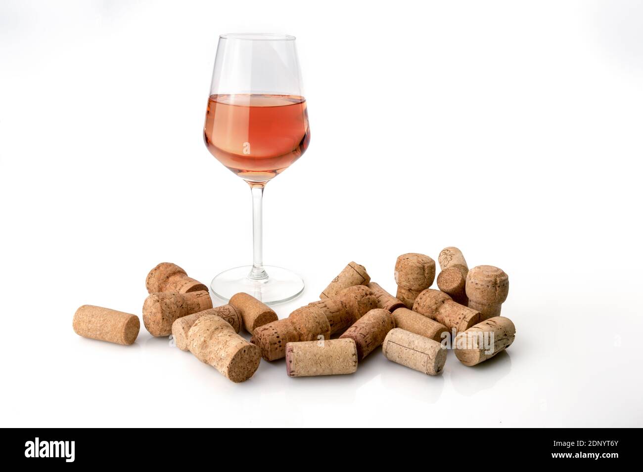 glass of rose wine with scattered used corks on white background Stock  Photo - Alamy