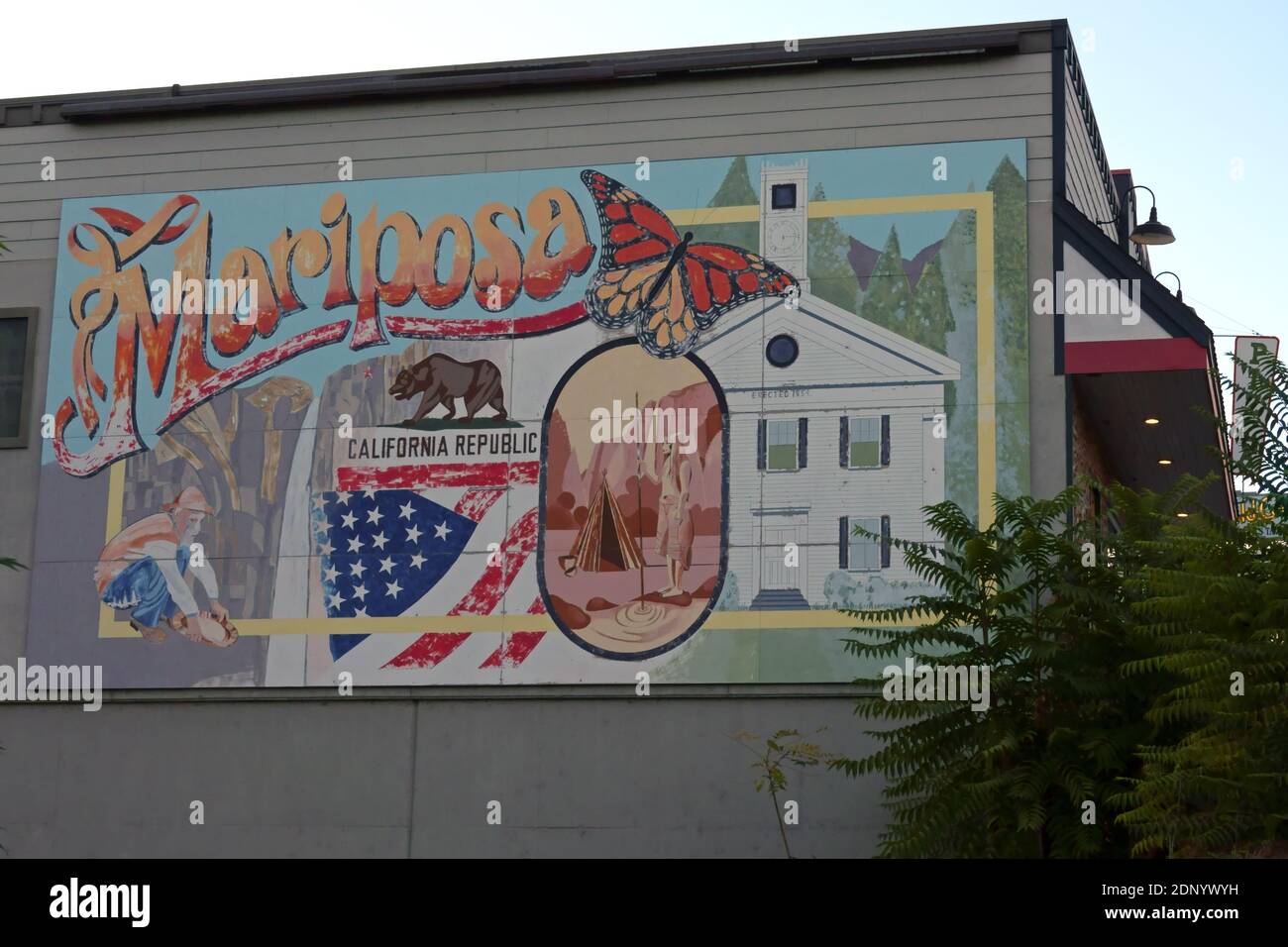 Mariposa, CA / USA - Oct. 18, 2020: A large mural, painted in 2008 and depicting the town’s historic past, is shown on the side of a building. Stock Photo