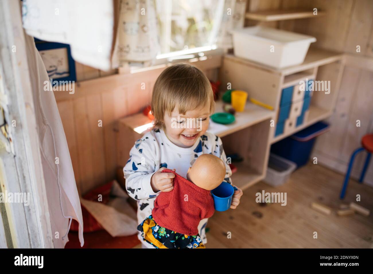 Toddler girl in playhouse Stock Photo Alamy