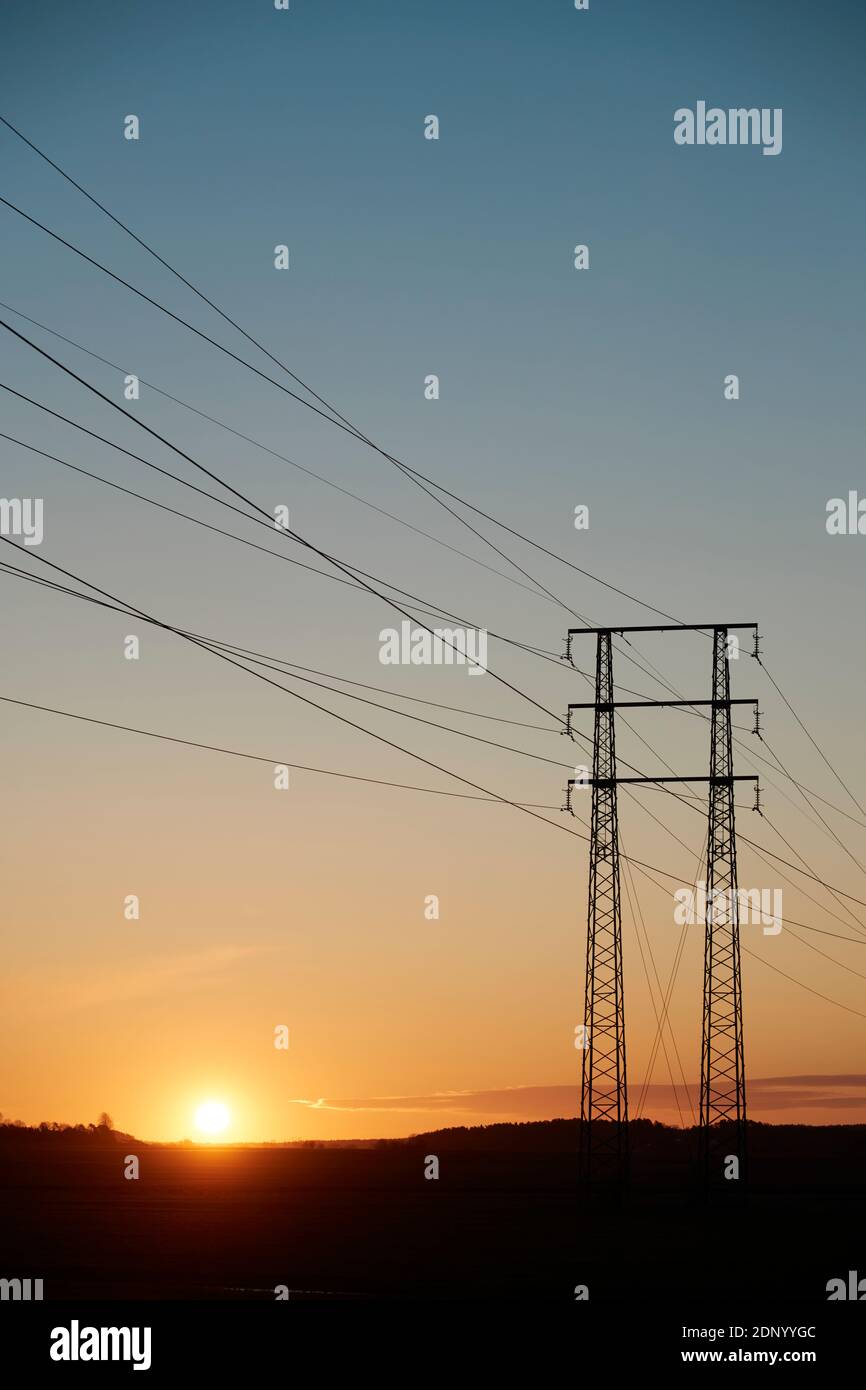 Silhouette of electricity pylon at sunset Stock Photo - Alamy
