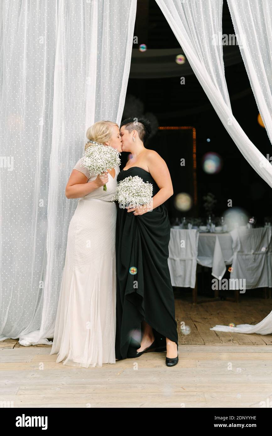 Brides kissing at wedding Stock Photo