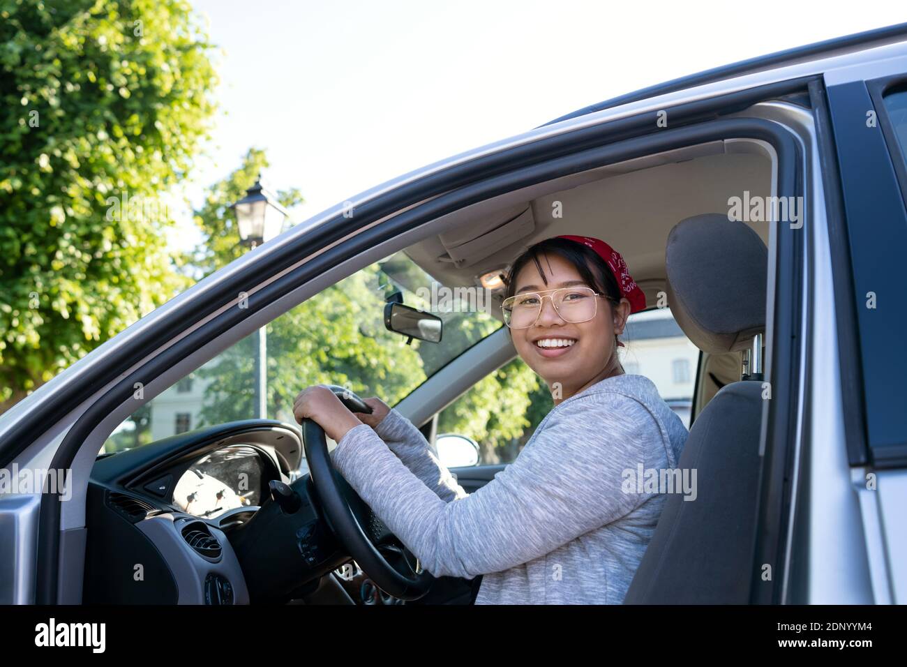 Smiling woman sitting in car Stock Photo
