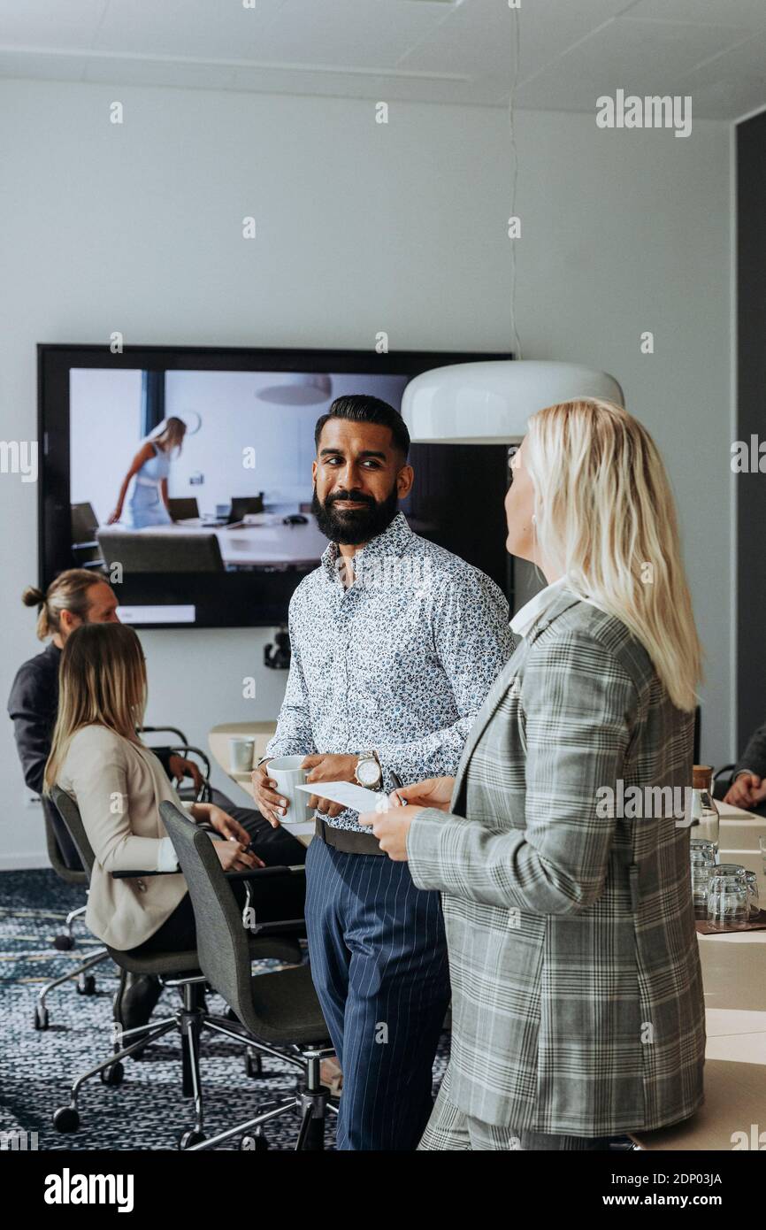 Coworkers talking in boardroom Stock Photo