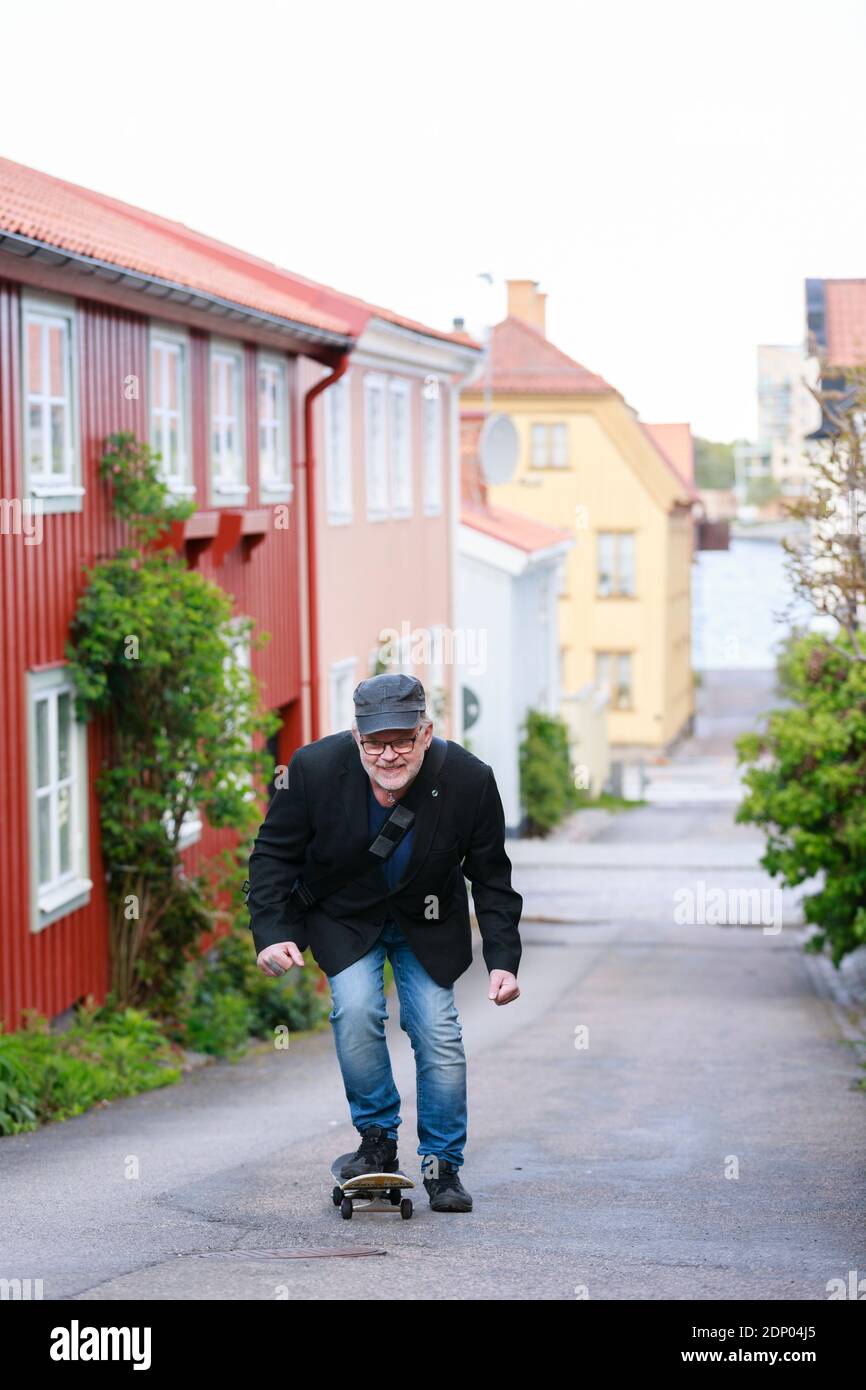 Man skateboarding on street Stock Photo