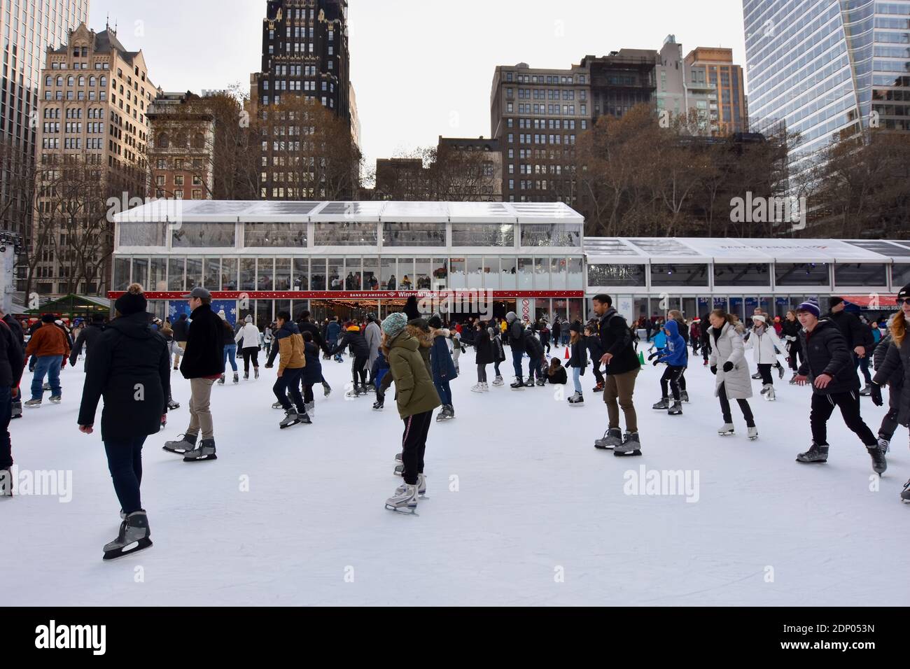 Crowd of people on the Ice Skating Rink at Bryant Park Winter Village during the holidays in New York City Stock Photo