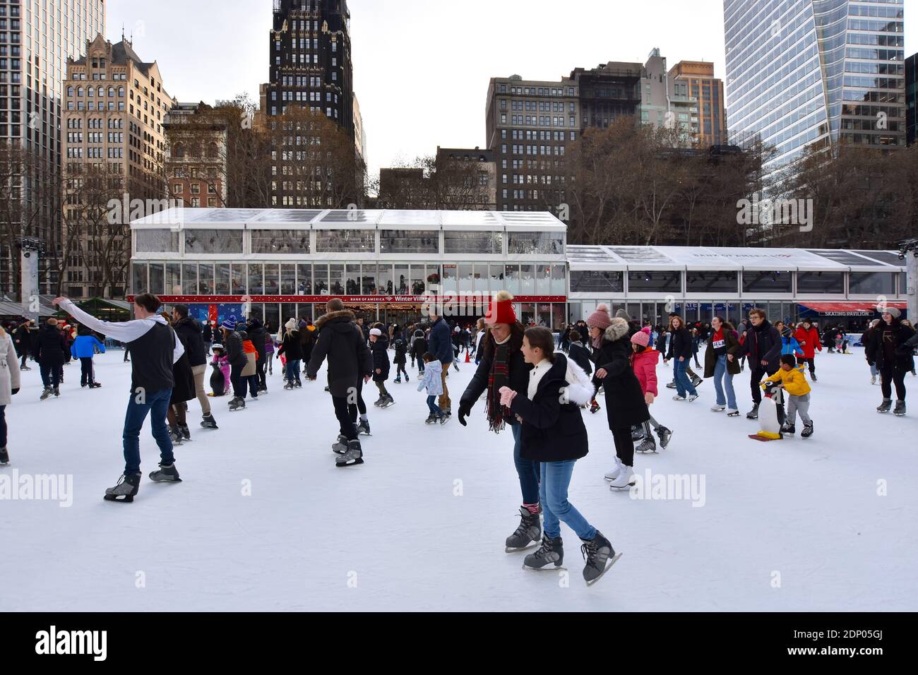 Crowd of people on the Ice Skating Rink at Bryant Park Winter Village during the holidays in New York City Stock Photo