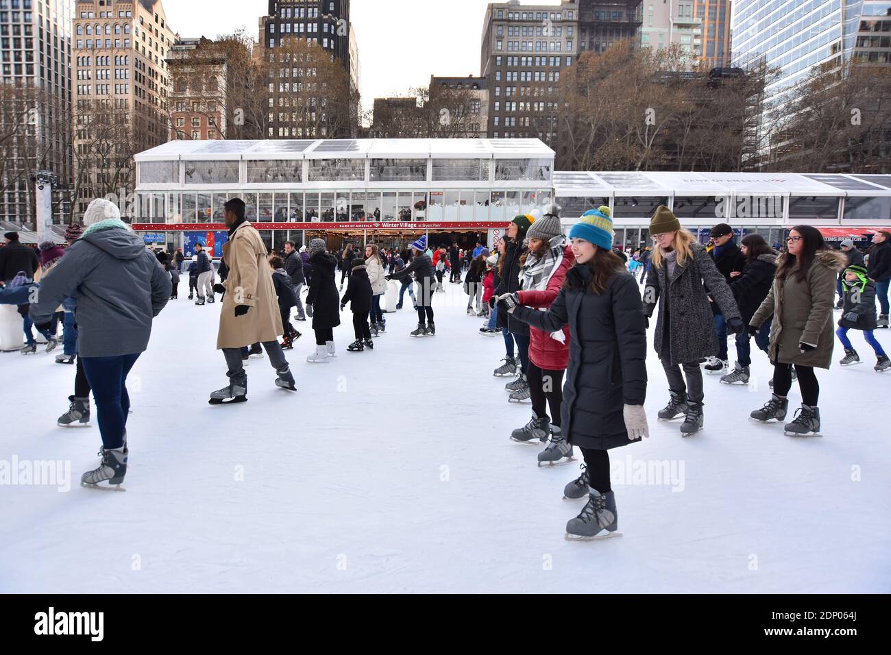 Manhattan, New York City, United States - December 10, 2019. Crowd of people on the Ice Skating Rink at Bryant Park Winter Village during the holidays Stock Photo